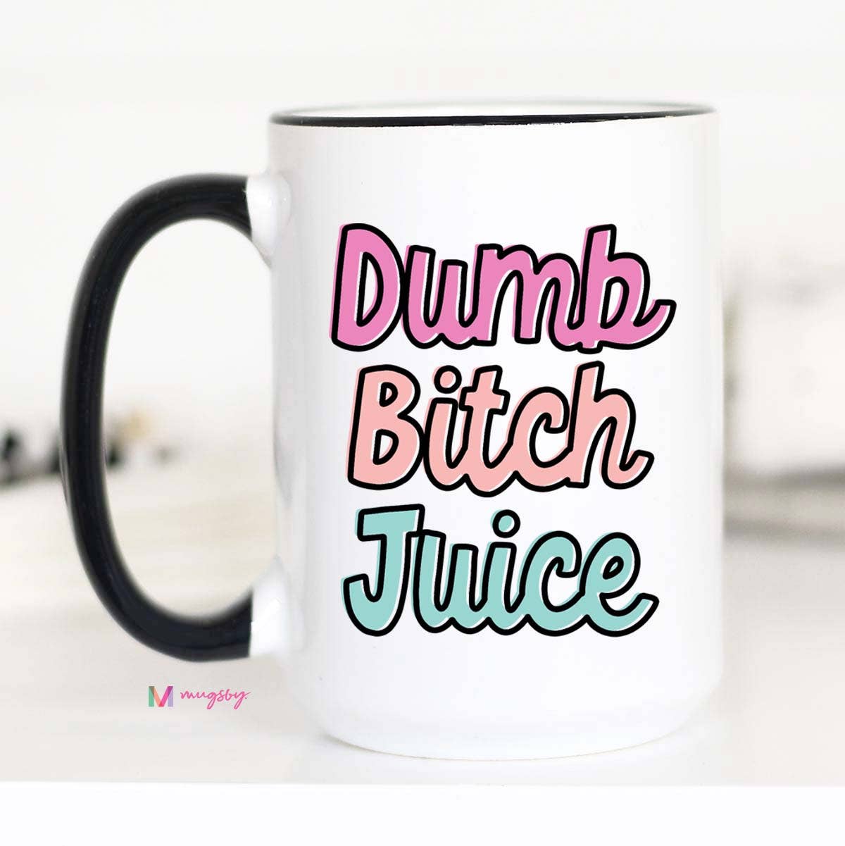 A white ceramic coffee mug with the text 'DUMB BITCH JUICE' printed in bold letters, accompanied by a black rim and handle.